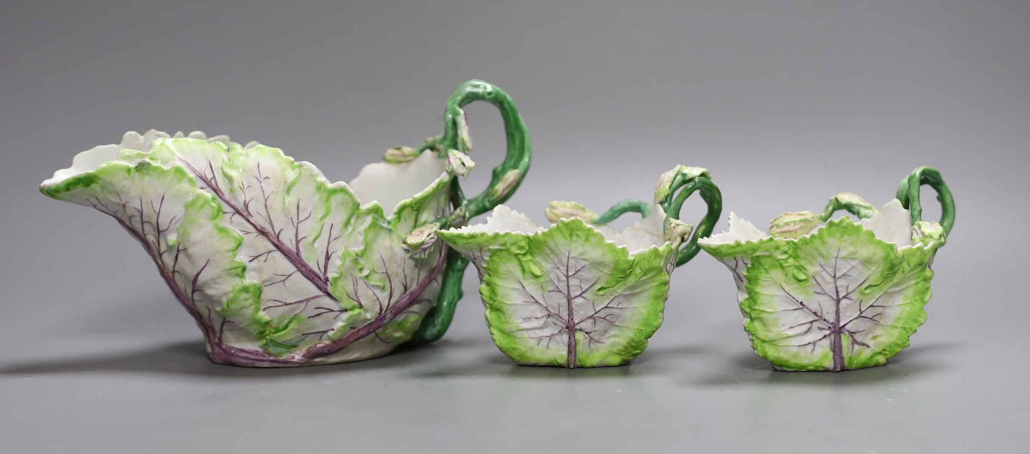 A Longton Hall cabbage leaf sauceboat and two similar creamboats, c.1755, faults and Newhall type tea wares, largest jug 22 cms wide